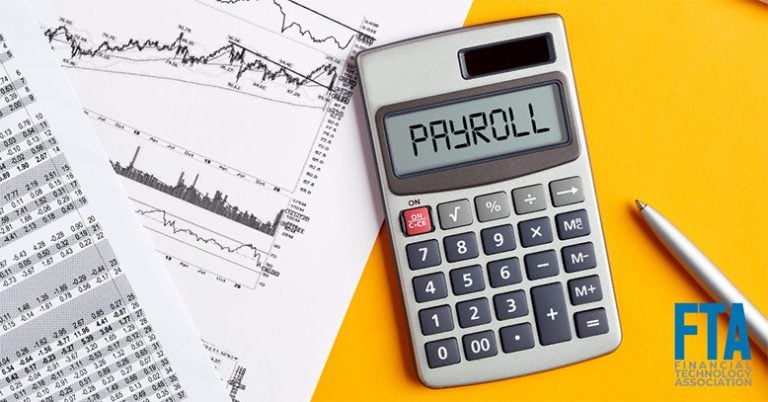a table with a calculator showing payroll with financial charts