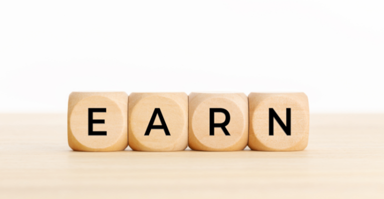wooden blocks spelling out the word "EARN"
