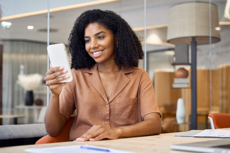 young woman holding up smartphone